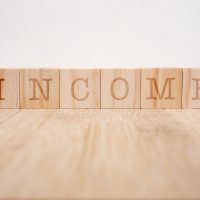 Wooden blocks with the word Income. Business and finance concept